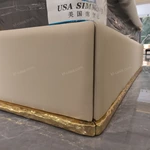 Beige Leather Upholstered Bed with Gold Stainless Steel Elephant Head Accents & Hammered Base Trim